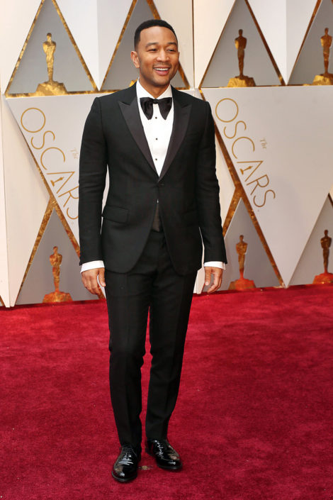 John-Legend-wearing-a-70s-inspired-huge-floppy-bow-tie-with-peaked-lapel-1-button-tux-with-flap-pockets-and-patent-leather-captoe-Oxfords.-Note-his-sleeves-are-too-long--470x705 (1).jpg